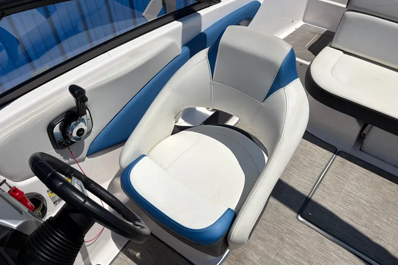 Slide: The Image of 2016 Regal 1900 ESX Bowrider interior with steering wheel and cushioned seating. - 13