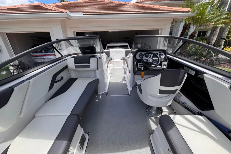 Slide: The Image of 2022 Yamaha Boats AR210 interior with sleek seating and modern dashboard design. - 25