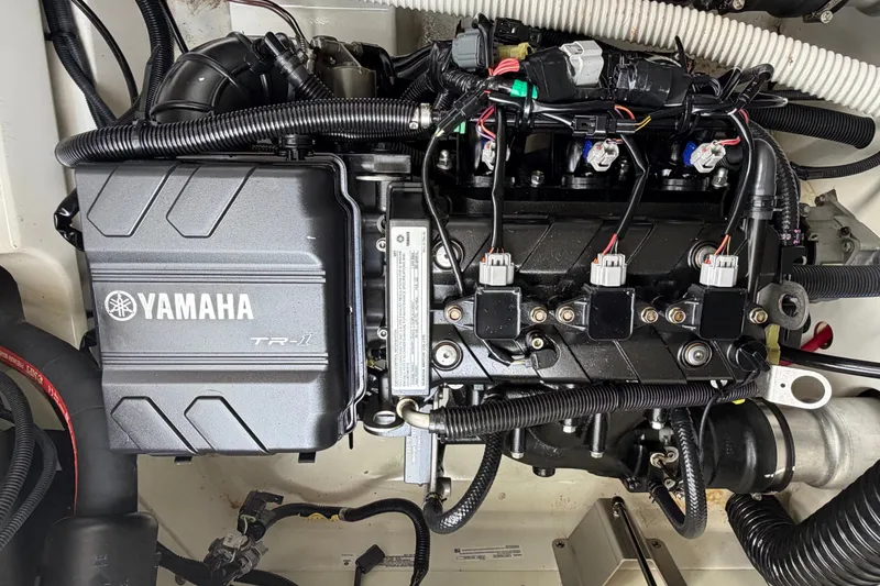 Slide: The Image of 2022 Yamaha AR210 engine compartment showcasing detailed components and wiring. - 38