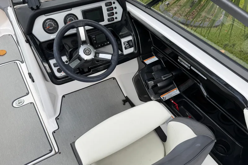 Slide: The Image of 2022 Yamaha Boats AR210 cockpit with steering wheel and control panel. - 19
