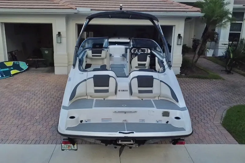Slide: The Image of 2022 Yamaha Boats AR210 parked in a driveway, showcasing sleek design and modern features. - 14