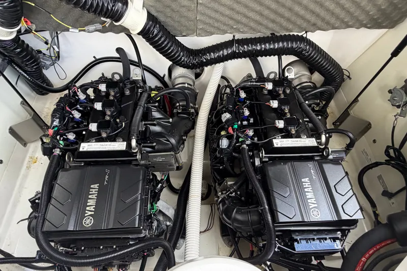 Slide: The Image of 2022 Yamaha AR210 boat engine compartment with dual Yamaha TR-1 engines. - 37