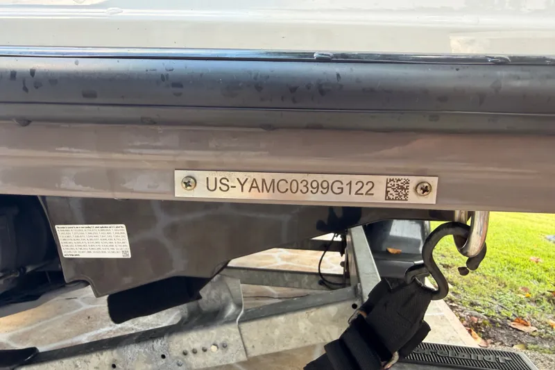 Slide: The Image of 2022 Yamaha AR210 boat hull identification number with QR code and trailer hook. - 44