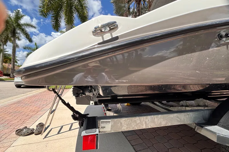 Slide: The Image of 2022 Yamaha Boats AR210 on trailer, parked under palm trees, sunny day. - 54