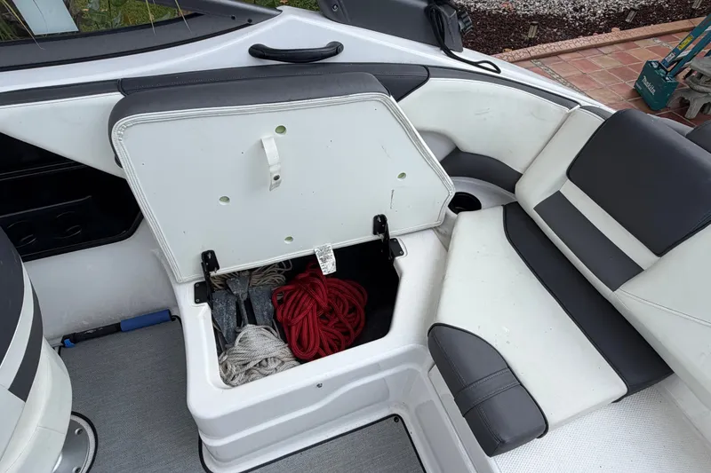 Slide: The Image of 2022 Yamaha AR210 boat storage compartment with ropes and accessories. - 16