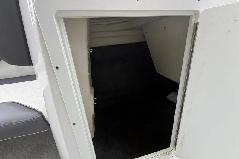 Slide: The Image of Storage compartment inside a 2022 Yamaha Boats AR210, featuring a spacious interior. - 32