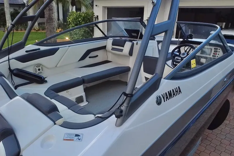 Slide: The Image of 2022 Yamaha AR210 boat interior with sleek seating and modern dashboard design. - 15