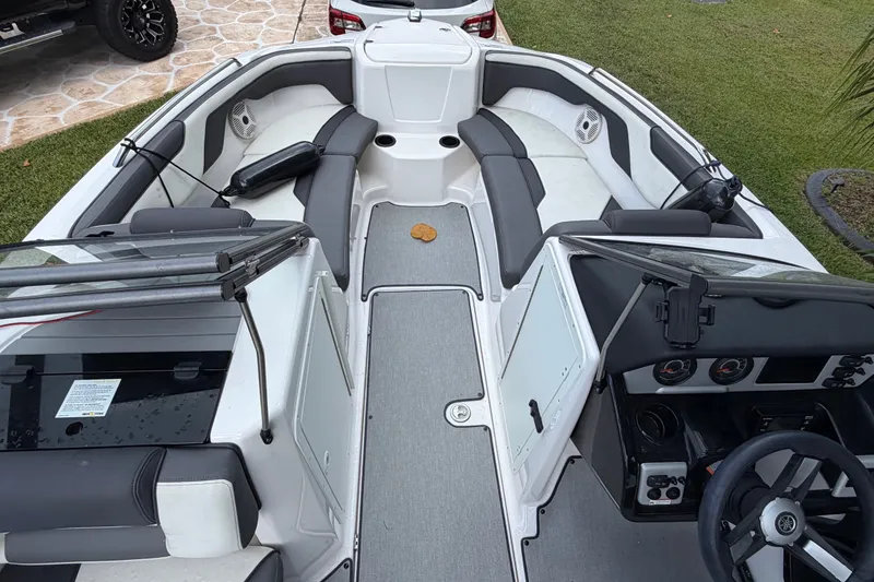Slide: The Image of 2022 Yamaha Boats AR210 interior with sleek seating and modern dashboard design. - 25