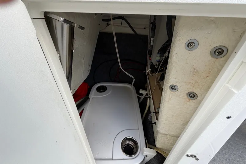 Slide: The Image of 2022 Yamaha AR210 boat storage compartment with equipment and wiring. - 31