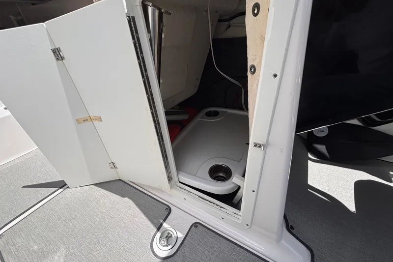 Slide: The Image of Open storage compartment on a 2022 Yamaha Boats AR210, showcasing interior details. - 40