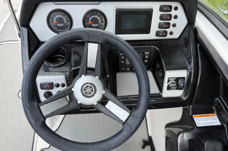 Slide: The Image of 2022 Yamaha AR210 boat dashboard with steering wheel and control panel. - 21