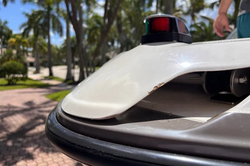 Slide: The Image of Close-up of 2022 Yamaha AR210 boat with visible hull damage. - 52