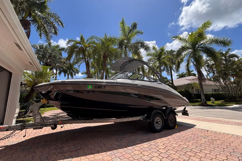 Slide: The Image of 2022 Yamaha AR210 boat on trailer, surrounded by palm trees and clear sky. - 3