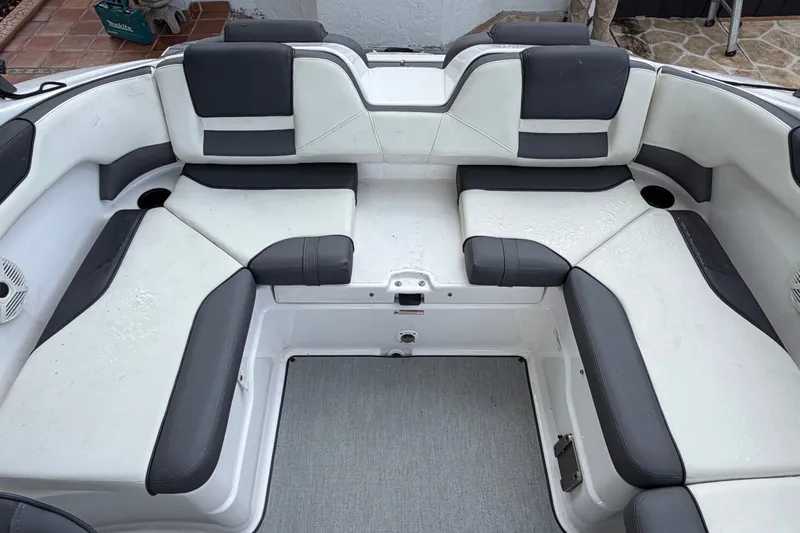 Slide: The Image of 2022 Yamaha Boats AR210 interior seating with black and white upholstery. - 10