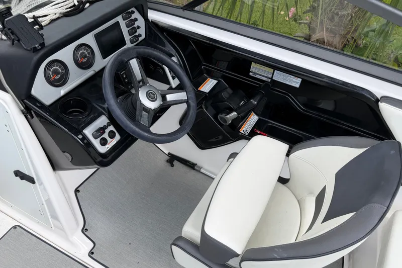 Slide: The Image of 2022 Yamaha AR210 boat cockpit with steering wheel and control panel. - 18