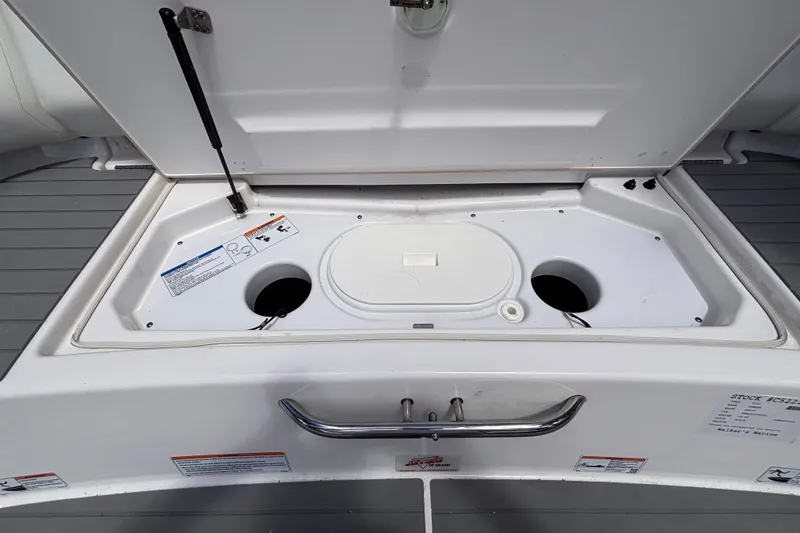 Slide: The Image of Open storage compartment on a 2022 Yamaha AR210 boat, showcasing interior features. - 23