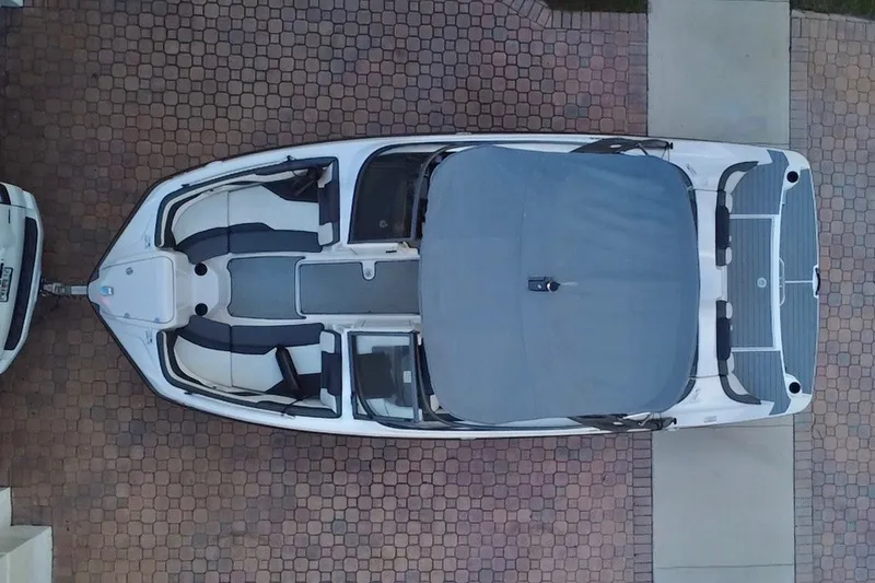 Slide: The Image of Overhead view of a 2022 Yamaha AR210 boat on a brick driveway. - 11