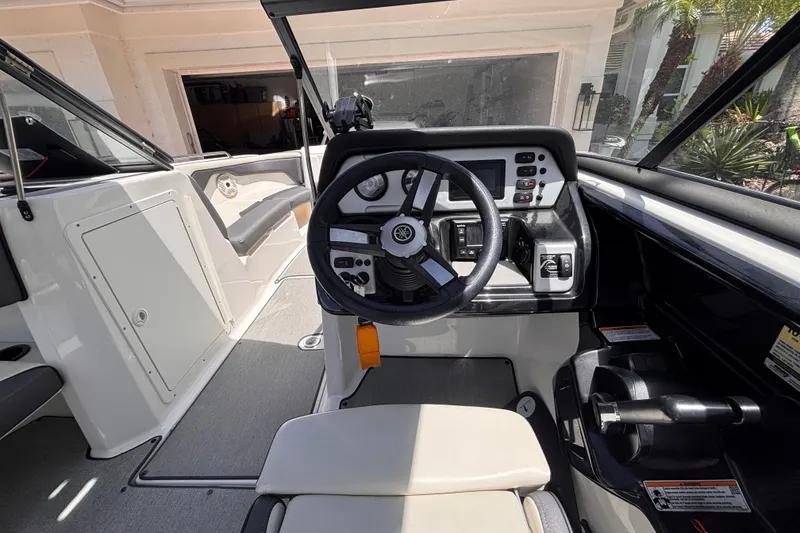 Slide: The Image of 2022 Yamaha Boats AR210 cockpit with steering wheel and control panel in a sleek design. - 31