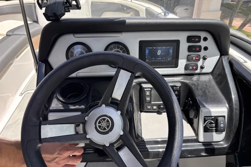 Slide: The Image of 2022 Yamaha Boats AR210 dashboard with steering wheel and control panel. - 32