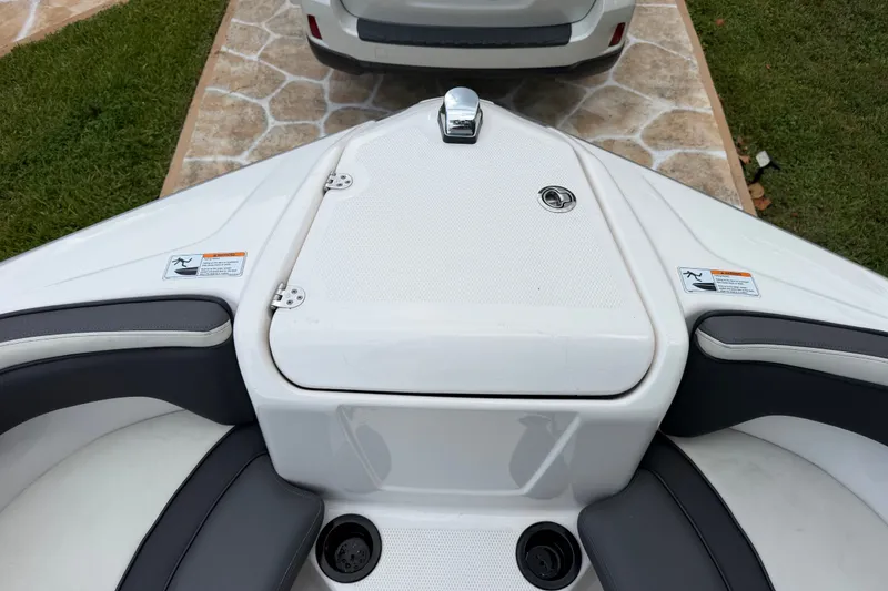 Slide: The Image of 2022 Yamaha AR210 boat interior with seating and storage compartment. - 35
