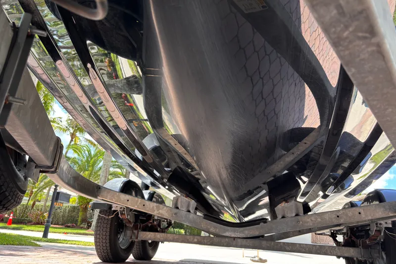 Slide: The Image of Underside view of a 2022 Yamaha Boats AR210 on a trailer. - 48
