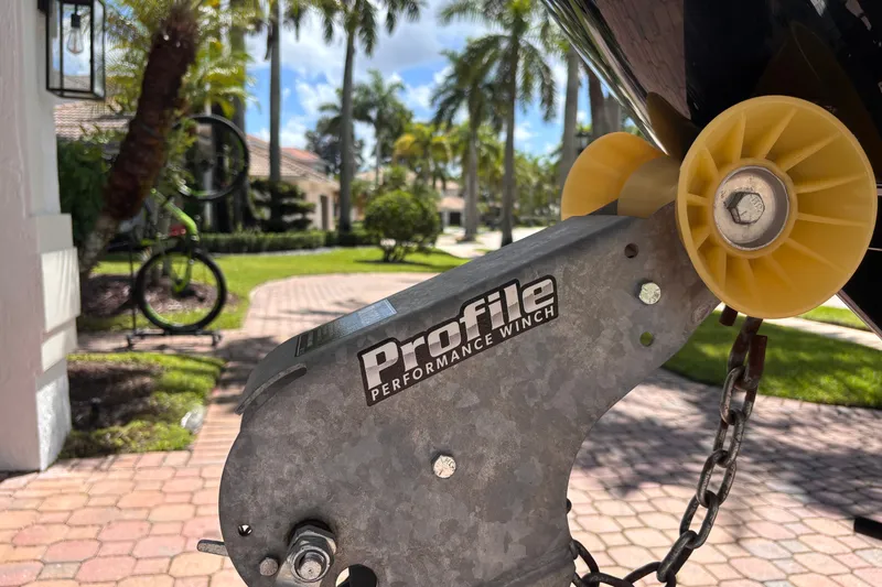 Slide: The Image of Close-up of a Profile Performance Winch on a 2022 Yamaha AR210 boat trailer. - 50