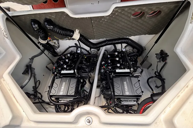 Slide: The Image of The engine compartment of a 2022 Yamaha AR210 boat showing two Yamaha engines and wiring. - 22