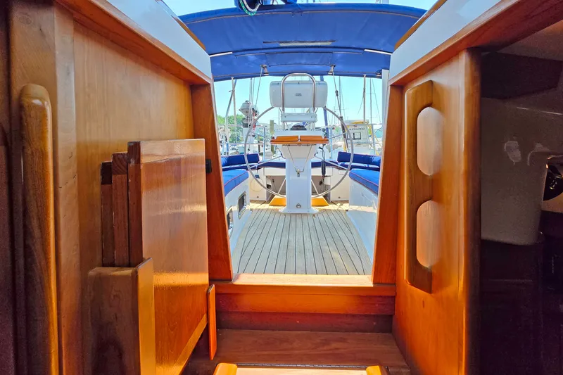 Slide: The Image of Interior view of 2008 Tartan 4300 sailboat, showcasing wooden cabin entrance and cockpit. - 21