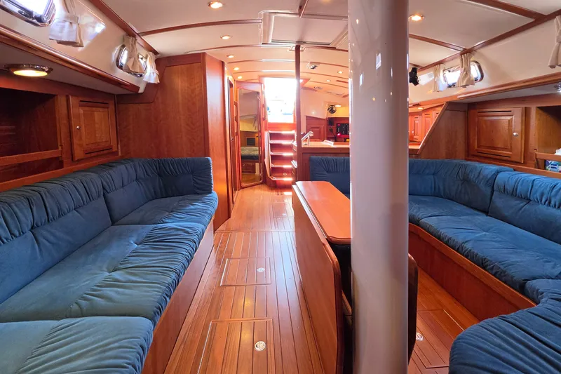 Slide: The Image of Luxurious 2008 Tartan 4300 yacht interior with plush blue seating and elegant wood finishes. - 22