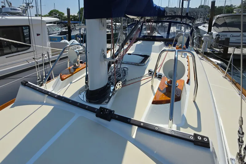 Slide: The Image of Deck view of a 2008 Tartan 4300 sailboat docked at a marina. - 16