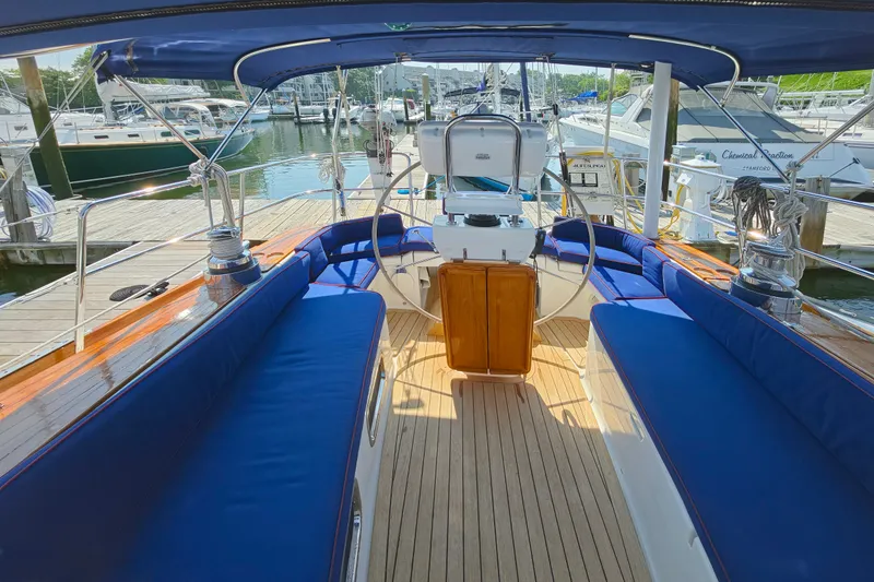 Slide: The Image of Luxurious 2008 Tartan 4300 yacht interior with blue seating at marina dock. - 7