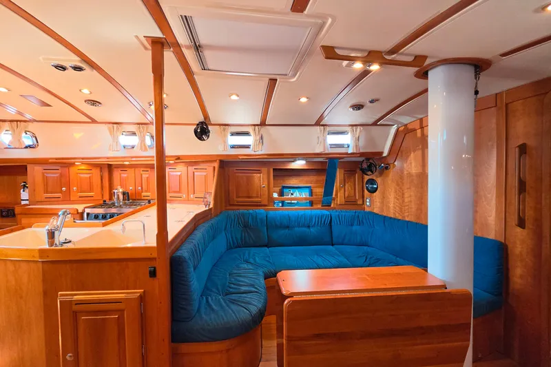 Slide: The Image of Luxurious 2008 Tartan 4300 yacht interior with wooden cabinetry and blue seating. - 26