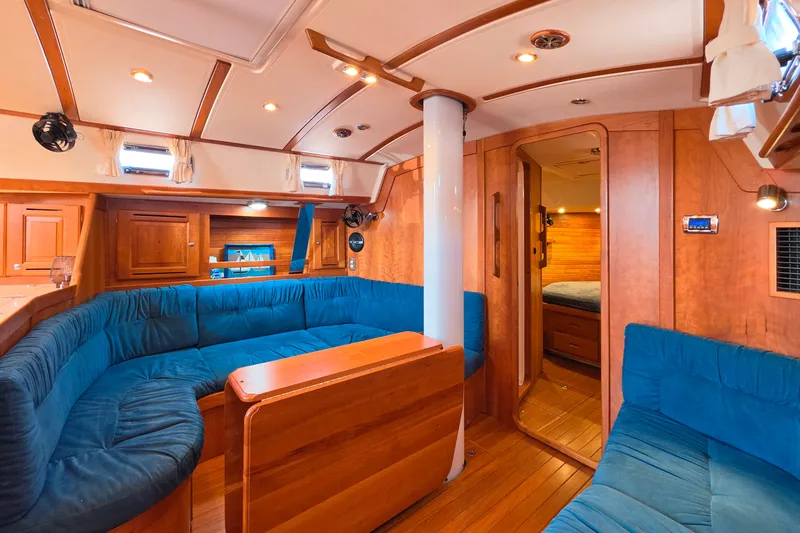 Slide: The Image of Luxurious 2008 Tartan 4300 yacht interior with blue seating and wooden finishes. - 24