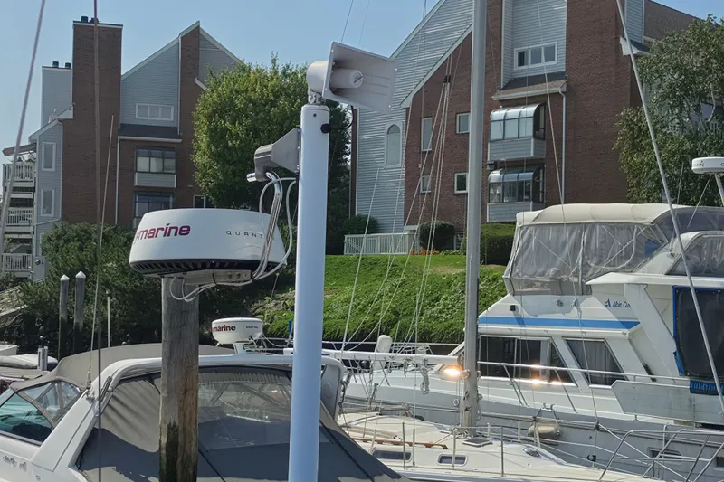 Slide: The Image of Boats docked near waterfront buildings, featuring a 2008 Tartan 4300 sailboat. - 20