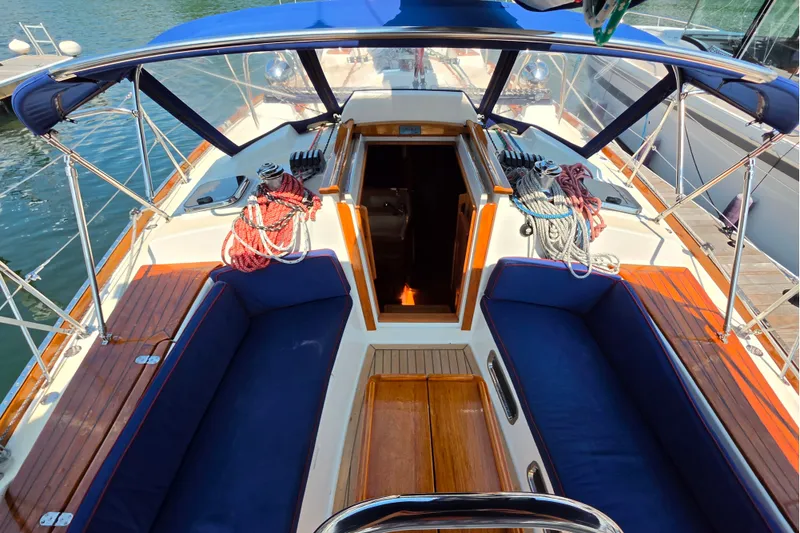 Slide: The Image of 2008 Tartan 4300 sailboat cockpit with blue cushions and neatly coiled ropes. - 6