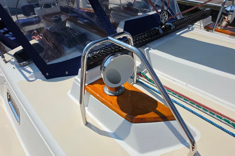 Slide: The Image of Close-up of a 2008 Tartan 4300 sailboat deck with polished metal and wood accents. - 15
