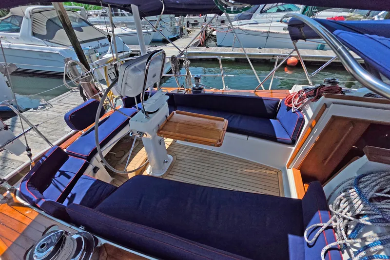 Slide: The Image of Cockpit of 2008 Tartan 4300 sailboat with blue cushions and wooden accents. - 5