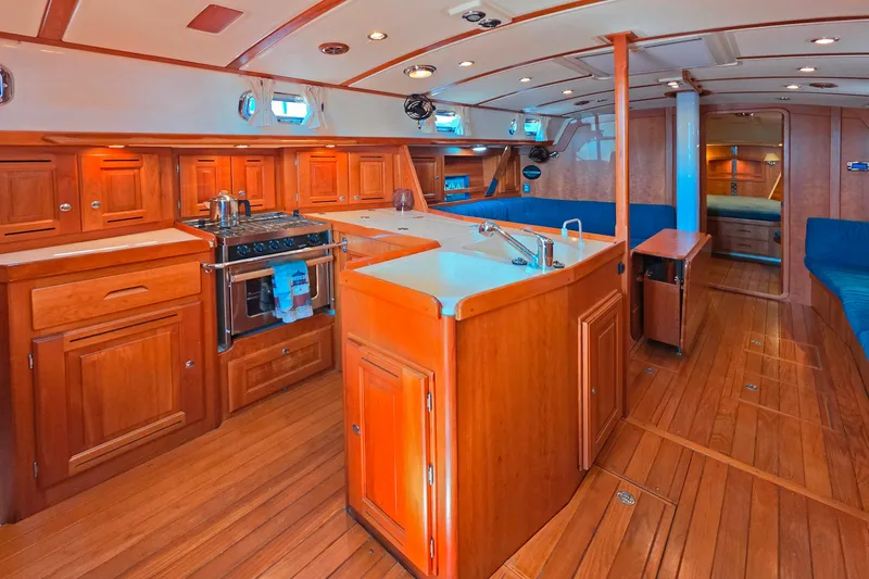 Slide: The Image of Luxurious 2008 Tartan 4300 yacht interior with wooden cabinetry and modern kitchen amenities. - 28