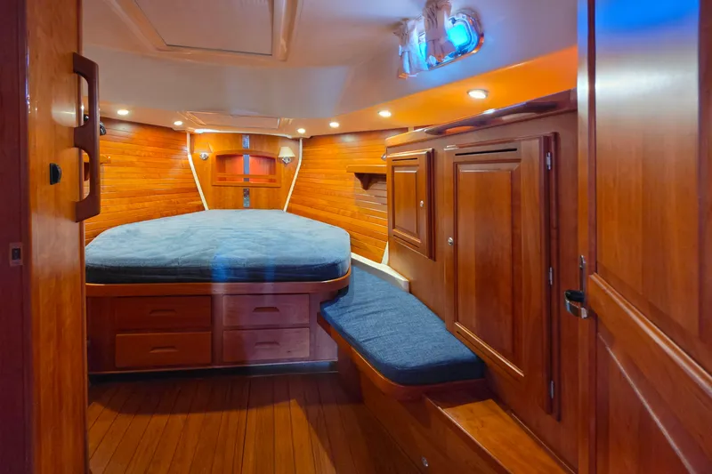 Slide: The Image of Luxurious wooden cabin interior of 2008 Tartan 4300 yacht with cozy bed and storage. - 34