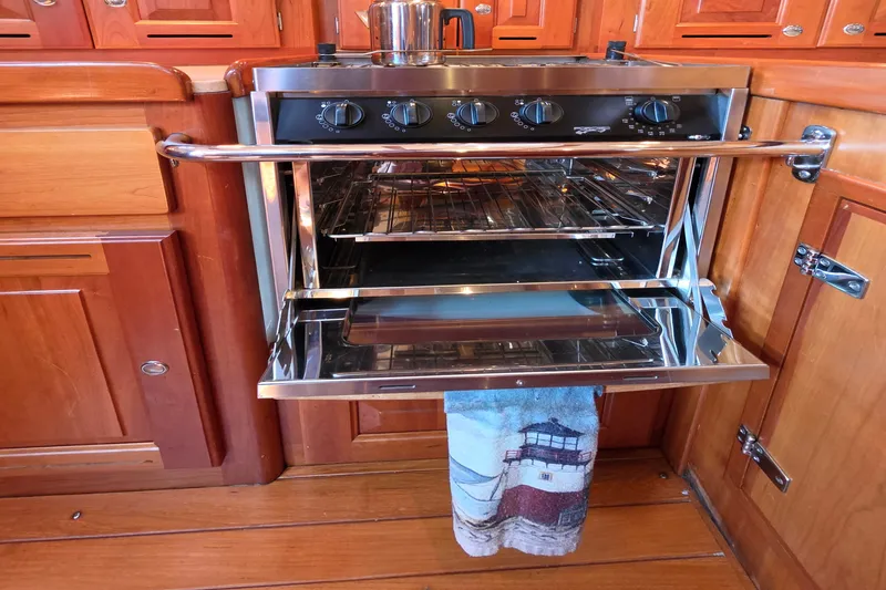 Slide: The Image of Stainless steel Tartan 4300 oven in wooden kitchen, open door, towel hanging. - 30