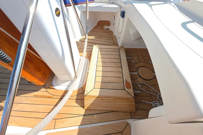 Slide: The Image of Wooden deck of 2008 Tartan 4300 sailboat with ropes and metal railings. - 10