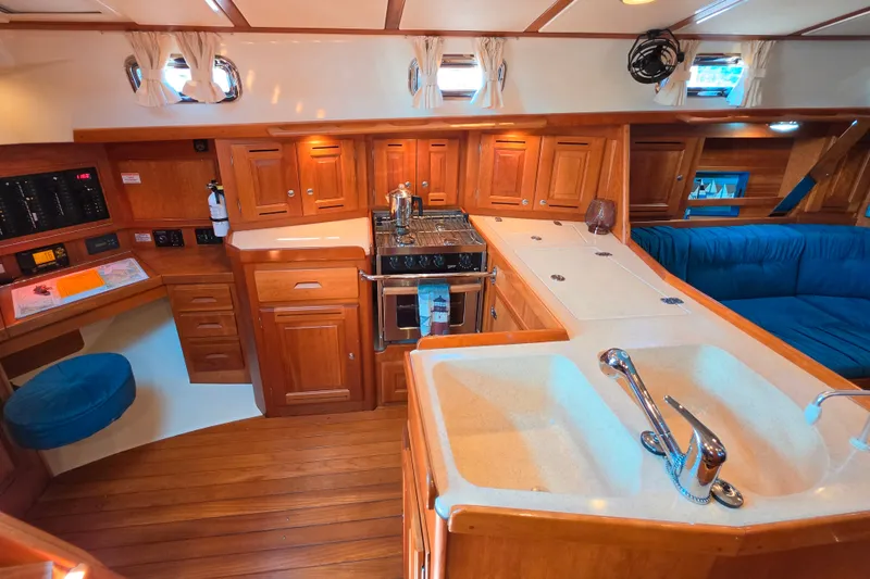 Slide: The Image of Luxurious 2008 Tartan 4300 yacht interior with wooden cabinetry and modern kitchen amenities. - 27