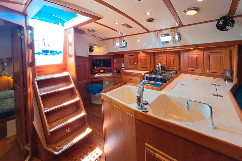 Slide: The Image of Luxurious 2008 Tartan 4300 yacht interior with wooden cabinetry and modern kitchen amenities. - 41