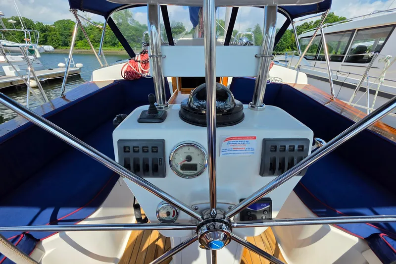 Slide: The Image of Cockpit of 2008 Tartan 4300 sailboat with steering wheel and navigation instruments. - 9