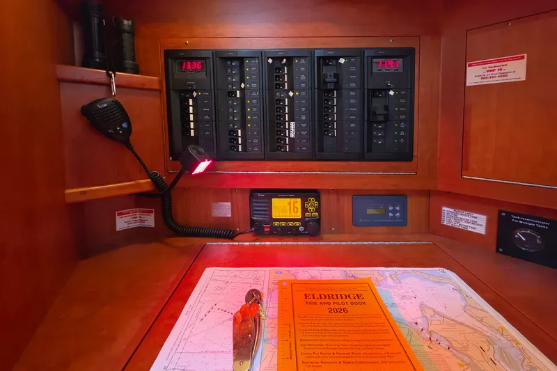 Slide: The Image of Navigation station on a 2008 Tartan 4300 yacht with control panels and charts. - 43