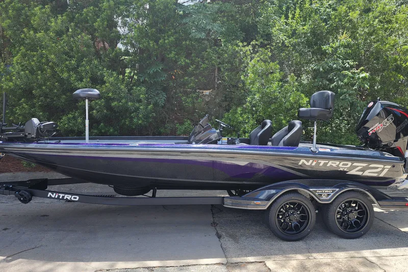 The Image of 2027 Nitro Z21 XL Pro bass boat on trailer, parked outdoors. - 1