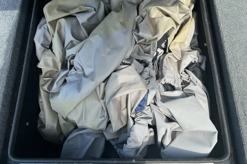 Slide: The Image of Crumbled fabric inside a storage compartment of a 2003 Gambler 2100. - 17