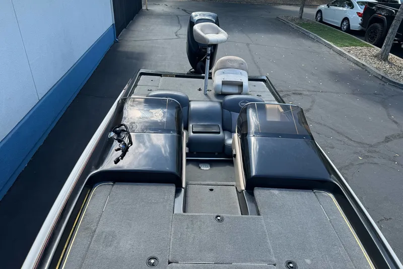 Slide: The Image of 2003 Gambler 2100 boat with dual consoles and seating, parked on pavement. - 14