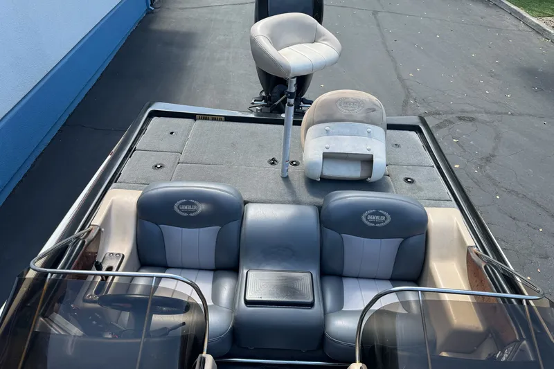 Slide: The Image of 2003 Gambler 2100 boat interior with gray seating and fishing deck. - 15