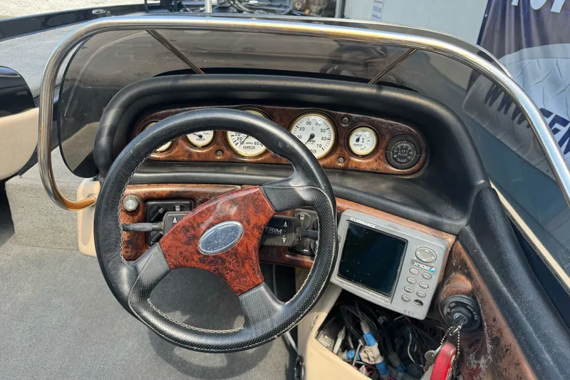 Slide: The Image of Dashboard of a 2003 Gambler 2100 boat with steering wheel and gauges. - 19